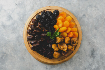 Dried fruits on wooden board, healthy snack, sweet fruits
