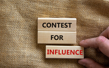 Contest for influence symbol. Wooden blocks with words 'Contest for influence'. Beautiful canvas background, businessman hand. Business, contest for influence concept, copy space.