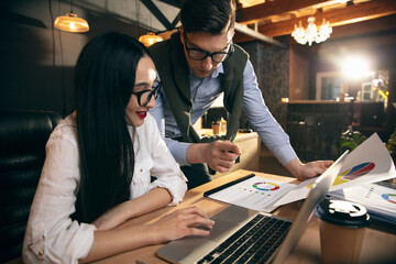 Colleagues working together in modern office using devices and gadgets during creative meeting