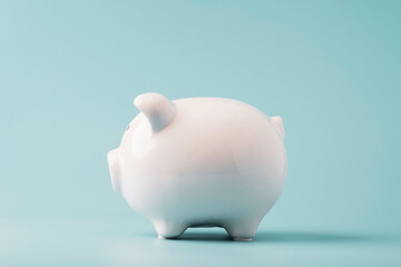 White  piggy bank saving on blue background and copy space ,Money saving for future investment and retirement concept.