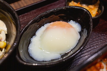 Onsen eggs in a black cup