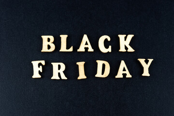 Wooden letters text BLACK FRIDAY in front black background, copy space, banner Top view Flat lay seasonal sale, retail, shopping concept. Black friday sale