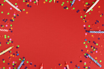 frame of Colorful birthday candles on a red background. Celebration party. Copy space for text