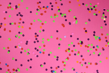 Texture background of colored confetti on a pink background