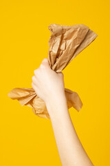 Hands hold recycling paper isolated on yellow background. Stop nature garbage, ecology environment protection concept. Save planet packaging mockup.