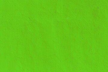 Bright green texture of a plastered wall in a modern style. Neon background for design and decor