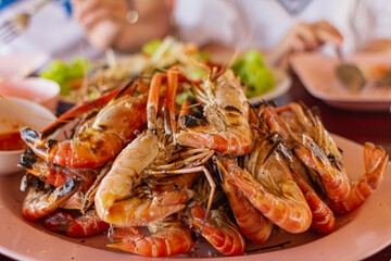 Several orange grilled prawns on a plate
