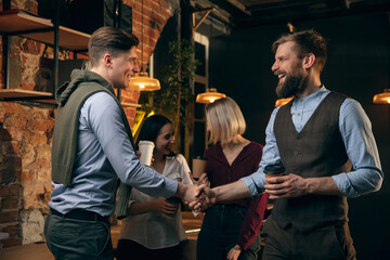 Colleagues working together in modern office using devices and gadgets during creative meeting