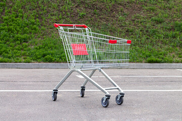 Empty shopping cart or trolley on suppermarket parking