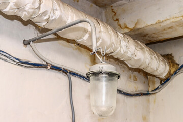 Old protected industrial light fixture in the basement