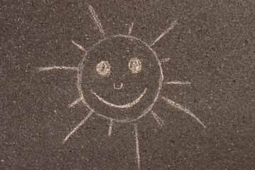 sun drawing on the asphalt sidewalk