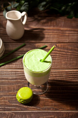 Dalgona Matcha Latte,creamy whipped matcha green tea with plant on the background
