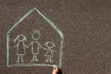 Happy family in the house, children's chalk drawing on the asphalt