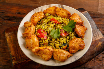 Food for suhoor in Ramadan bulgur post with beef in a plate on a wooden table.