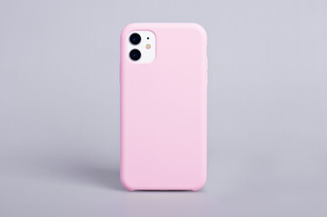 Pink phone case mockup. iPhone 11 mock up back view isolated on gray background