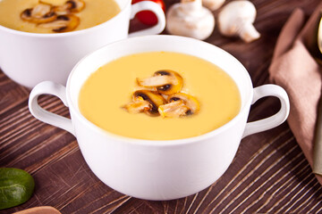 Cheese or onion cream soup with toasts bread in a white bowls