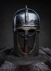 Steel helmet on stand against dark background