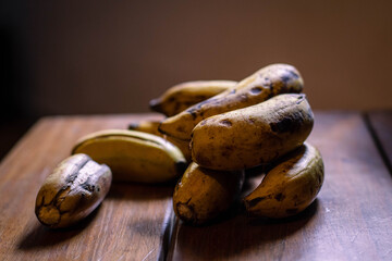 mini bananas on wooden base