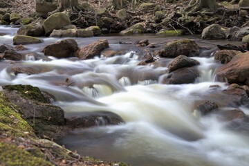 Fototapeta na wymiar longtime exposure of the river Ilse in Ilsenburg in the Harz, Germany