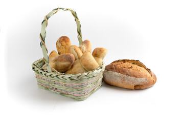Artisanal bread and buns in a wicker basket isolated on white
