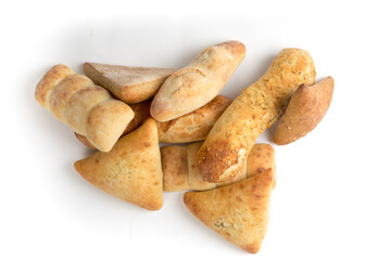 A pile of artisanal bread and buns isolated on white
