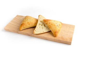 Artisanal bread or sour dough buns cut open on a wooden board isolated on white
