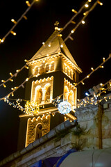 Obraz premium The night tower of the Lutheran Church of the Redeemer in the Christian Quarter, Old city East Jerusalem Israel. selective focus