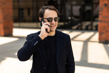 Handsome young businessman talking on the cellphone