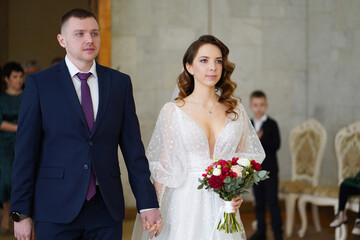 beautiful and happy bride and groom in the registry office