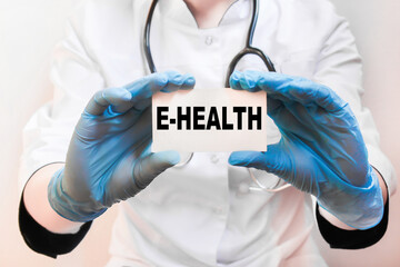the doctor in gloves holds a card with the text E-HEALTH . white background. the medicine