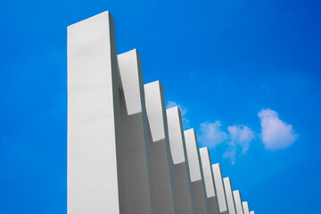 white concrete pillars with blue sky background.