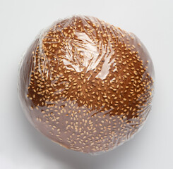 bun with sesame seeds in package isolated on white