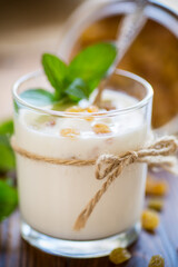 sweet homemade yogurt with raisins in a glass