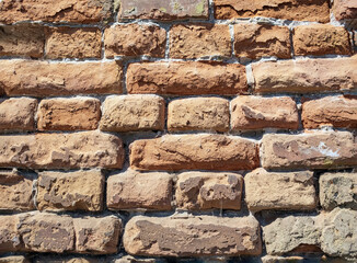 Background of red-brick masonry texture. Pattern of rude 500-years old wall. Close-up
