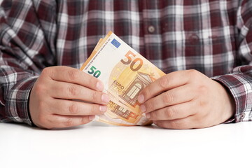 Man hands with banknotes on white table