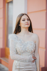 Vertical shot of a Caucasian female with beautiful jumpsuit posing outdoors