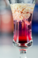 Interesting drink shot based on cream, liqueur and grenadine called Brain Hemorrhage prepared for Halloween party