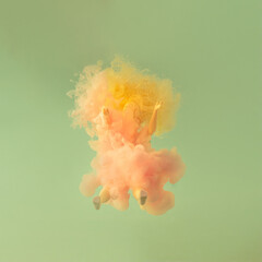 a girl with yellow hair in the water and fluid pastel pink color. summer abstract tropical minimal art with copy space.