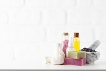 Obraz na płótnie Canvas Cosmetics bottles and natural handmade soap on white background