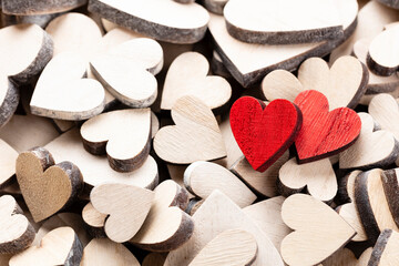 Wooden hearts, one red heart on the heart background..