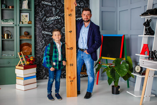 Father takes child to school. Back to school concept. Schoolboy go to first class. Education, elementary school. Daddy giving support his son for beggining school