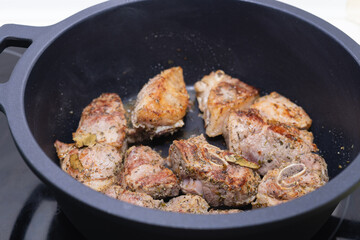 Meat being cooked in a pot. Cooking concept.