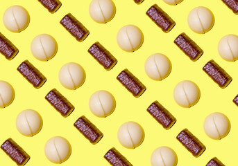Pattern of white and crocanti chocolate bonbons. International chocolate day