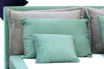 Textile pillows on bed