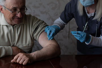 Happy senior man being vaccinated