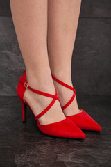 Female feet shod in red shoes 