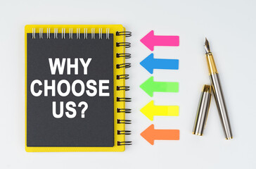 On a white background lies a pen, arrows and a notebook with the inscription - WHY CHOOSE US