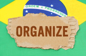 Against the background of the flag of Brazil lies cardboard with the inscription - organize