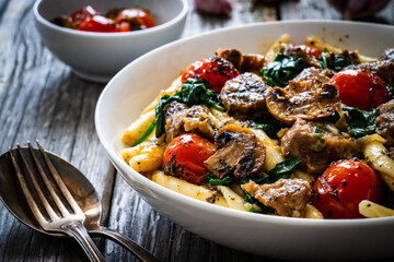 Maccheroni al ferretto with roast pork, cherry tomatoes, white mushrooms, parmesan cheese and...