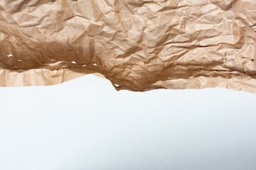 Crumpled craft paper, texture, white background, copy space